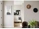 Cozy entryway with modern art, stylish hats on the wall, and a decorative bench with geometric throw pillow at 8280 E 36Th Ave # 27, Denver, CO 80238