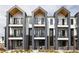 Contemporary townhouse featuring a stylish exterior with balconies and a mix of brick and siding, offering modern living at 8280 E 36Th Ave # 27, Denver, CO 80238