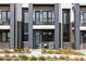 Modern townhome exterior with sleek design, brick accents, and private balconies at 8280 E 36Th Ave # 27, Denver, CO 80238