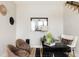 A modern home office space featuring two comfortable chairs and a sleek black desk with gold accents, ideal for productivity at 8280 E 36Th Ave # 27, Denver, CO 80238