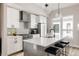 Modern kitchen features white cabinets, stainless steel appliances, and an island with seating at 8280 E 36Th Ave # 27, Denver, CO 80238