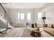 Bright and open living room featuring modern furnishings, large windows, and a cozy rug at 8280 E 36Th Ave # 27, Denver, CO 80238