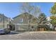 Exterior view of a townhouse with parking and a tree at 9032 Gale Blvd # 1, Thornton, CO 80260