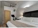 Bright bedroom with a comfortable bed, wood floors, and fitness equipment at 1020 15Th St # 210, Denver, CO 80202
