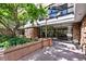 Stone and concrete building entrance with large glass windows and landscaping at 1020 15Th St # 210, Denver, CO 80202
