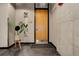 Hallway with neutral walls and modern touches, featuring a wooden door and mirror at 1020 15Th St # 210, Denver, CO 80202