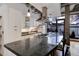 Modern kitchen showcasing a large island with cooktop and seating, bright white cabinetry, and hardwood flooring at 1020 15Th St # 210, Denver, CO 80202
