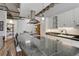 Stylish kitchen featuring an oversized island with cooktop, bar seating, and modern stainless steel range hood at 1020 15Th St # 210, Denver, CO 80202