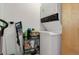 Efficient laundry area with stacked washer and dryer, plus shelving for supplies at 1020 15Th St # 210, Denver, CO 80202