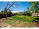 Lush green backyard with mature trees and privacy fence at 13895 W Atlantic Ave, Lakewood, CO 80228