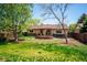 Expansive backyard with deck, pergola, mature trees and wooden fence at 13895 W Atlantic Ave, Lakewood, CO 80228