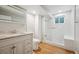Bright bathroom features a glass-enclosed shower, a modern vanity, and a commode for convenience at 13895 W Atlantic Ave, Lakewood, CO 80228