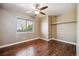 Inviting bedroom showcasing hardwood floors, a ceiling fan, and a sun-filled window with privacy blinds at 13895 W Atlantic Ave, Lakewood, CO 80228