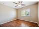 Inviting bedroom showcasing hardwood floors, a ceiling fan, and a sun-filled window with privacy blinds at 13895 W Atlantic Ave, Lakewood, CO 80228