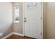 Bright entryway featuring a white front door with decorative glass and a sidelight window at 13895 W Atlantic Ave, Lakewood, CO 80228