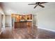 Open-concept kitchen with a center island, stainless steel appliances, and hardwood floors at 13895 W Atlantic Ave, Lakewood, CO 80228