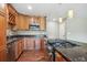 Kitchen features a gas cooktop on the island, wooden cabinets, and stainless steel appliances at 13895 W Atlantic Ave, Lakewood, CO 80228