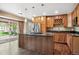 Modern kitchen featuring granite countertops, stainless steel appliances, and an island with a cooktop at 13895 W Atlantic Ave, Lakewood, CO 80228