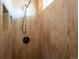 Close-up view of a shower showcasing the wood-look tile and modern fixtures at 13895 W Atlantic Ave, Lakewood, CO 80228