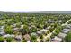 A lovely aerial shot of a neighborhood shows tree-lined streets with well-spaced homes at 10262 Spotted Owl Ave, Highlands Ranch, CO 80129