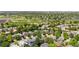 A picturesque aerial view of a neighborhood showcases tree-lined streets and nearby athletic fields at 10262 Spotted Owl Ave, Highlands Ranch, CO 80129
