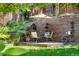 A relaxing backyard with a stone patio featuring outdoor seating and a charming retaining wall at 10262 Spotted Owl Ave, Highlands Ranch, CO 80129