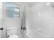 Bright, tiled bathroom featuring a toilet and a shower-tub combination at 10262 Spotted Owl Ave, Highlands Ranch, CO 80129