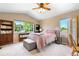 Cozy bedroom with bright windows, vaulted ceilings, and bookshelves for ample storage and display at 10262 Spotted Owl Ave, Highlands Ranch, CO 80129