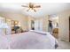 Relaxing bedroom with workspace area, private bathroom, and natural lighting at 10262 Spotted Owl Ave, Highlands Ranch, CO 80129