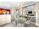 Inviting dining area with modern lighting, glass table and views of the living room and kitchen at 10262 Spotted Owl Ave, Highlands Ranch, CO 80129