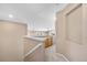Upstairs hallway with views of the living space, natural light, and a built-in cabinet at 10262 Spotted Owl Ave, Highlands Ranch, CO 80129