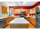 Bright kitchen with stainless steel appliances, center island, and wood cabinets at 10262 Spotted Owl Ave, Highlands Ranch, CO 80129