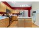 Kitchen with stainless appliances, center island and warm cabinets at 10262 Spotted Owl Ave, Highlands Ranch, CO 80129