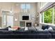 Spacious living room with high ceilings, fireplace, and ample natural light at 10262 Spotted Owl Ave, Highlands Ranch, CO 80129