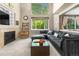 Inviting living room featuring a fireplace, large windows, and comfortable seating at 10262 Spotted Owl Ave, Highlands Ranch, CO 80129