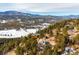 Aerial view features mountain homes against a snow-covered valley backdrop at 9189 Fallen Rock Rd, Conifer, CO 80433