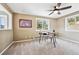 Comfortable bedroom features a ceiling fan, carpet, and a lovely view from its two large windows at 9189 Fallen Rock Rd, Conifer, CO 80433