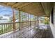 Exterior view from covered deck with wood flooring, railings, and wooded views at 9189 Fallen Rock Rd, Conifer, CO 80433