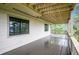 Spacious covered deck with wood flooring, railings, and wooded views at 9189 Fallen Rock Rd, Conifer, CO 80433