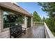 A view of the stained-wood deck, railings, and bench on the exterior of the home at 9189 Fallen Rock Rd, Conifer, CO 80433