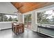 Bright dining room with wood table, access to a deck, and large windows showcasing scenic mountain views at 9189 Fallen Rock Rd, Conifer, CO 80433