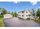 An exterior front view of a home with a two-car detached garage and large driveway at 9189 Fallen Rock Rd, Conifer, CO 80433