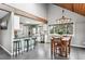 Open kitchen and dining area with granite counters, stainless steel appliances, and breakfast bar seating at 9189 Fallen Rock Rd, Conifer, CO 80433