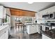 Open-concept kitchen featuring granite countertops, a dining area, stainless steel appliances, and a wood ceiling at 9189 Fallen Rock Rd, Conifer, CO 80433