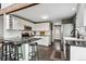 Bright and updated kitchen featuring granite countertops, white cabinetry, and stainless steel appliances at 9189 Fallen Rock Rd, Conifer, CO 80433