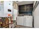 Laundry area equipped with modern washer and dryer, plus cabinet storage at 9189 Fallen Rock Rd, Conifer, CO 80433