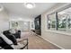 Living room features carpeted floors, a TV, and a sliding glass door with access to a porch at 9189 Fallen Rock Rd, Conifer, CO 80433
