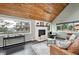 Inviting living room featuring vaulted wood ceilings, a cozy fireplace, and large windows with picturesque mountain views at 9189 Fallen Rock Rd, Conifer, CO 80433