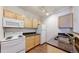 Close-up of the updated kitchen area showing countertops, stainless sink, and cabinets, alongside the stove and refrigerator at 444 17Th St # 301, Denver, CO 80202