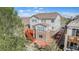 Aerial view of a two-story home, featuring a large wooden deck, a lush yard, and multi-toned roof at 3266 Yale Dr, Broomfield, CO 80023